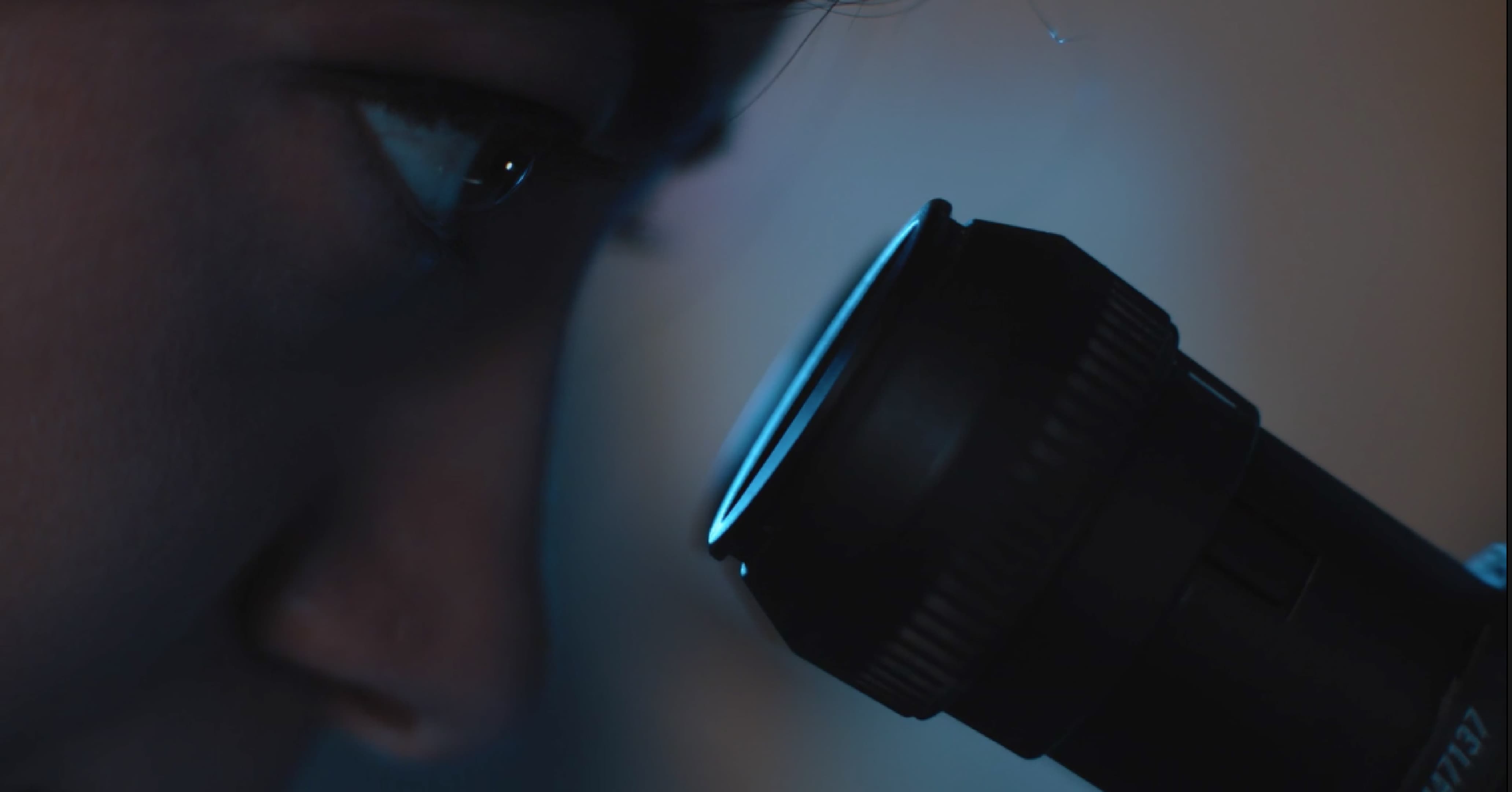 Technician studying antigens in microscope